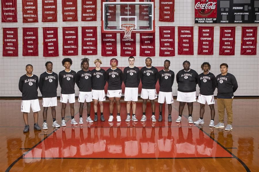 2022-23 ASD boys varsity basketball team posed for team photo in gym